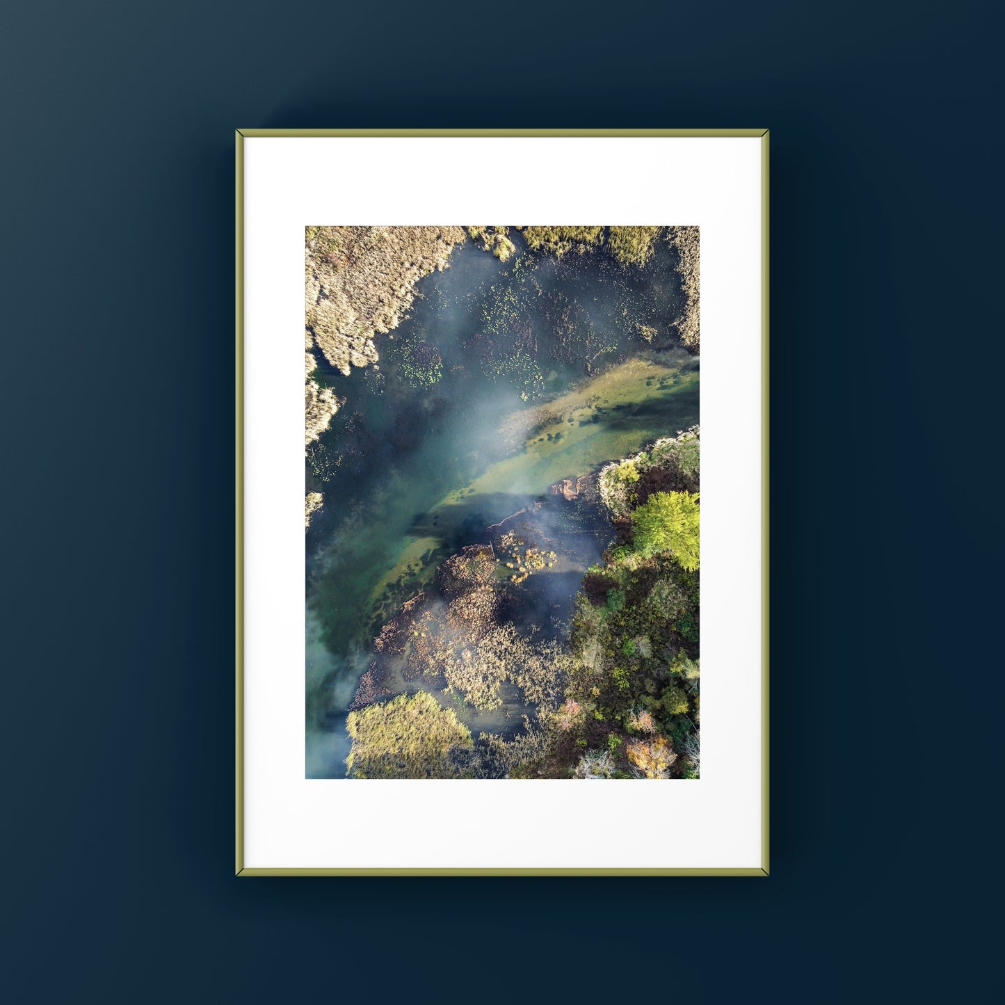 Aerial view of a river with green moss and shadows, the water is a deep turquoise blue, abstract nature photography print for sale