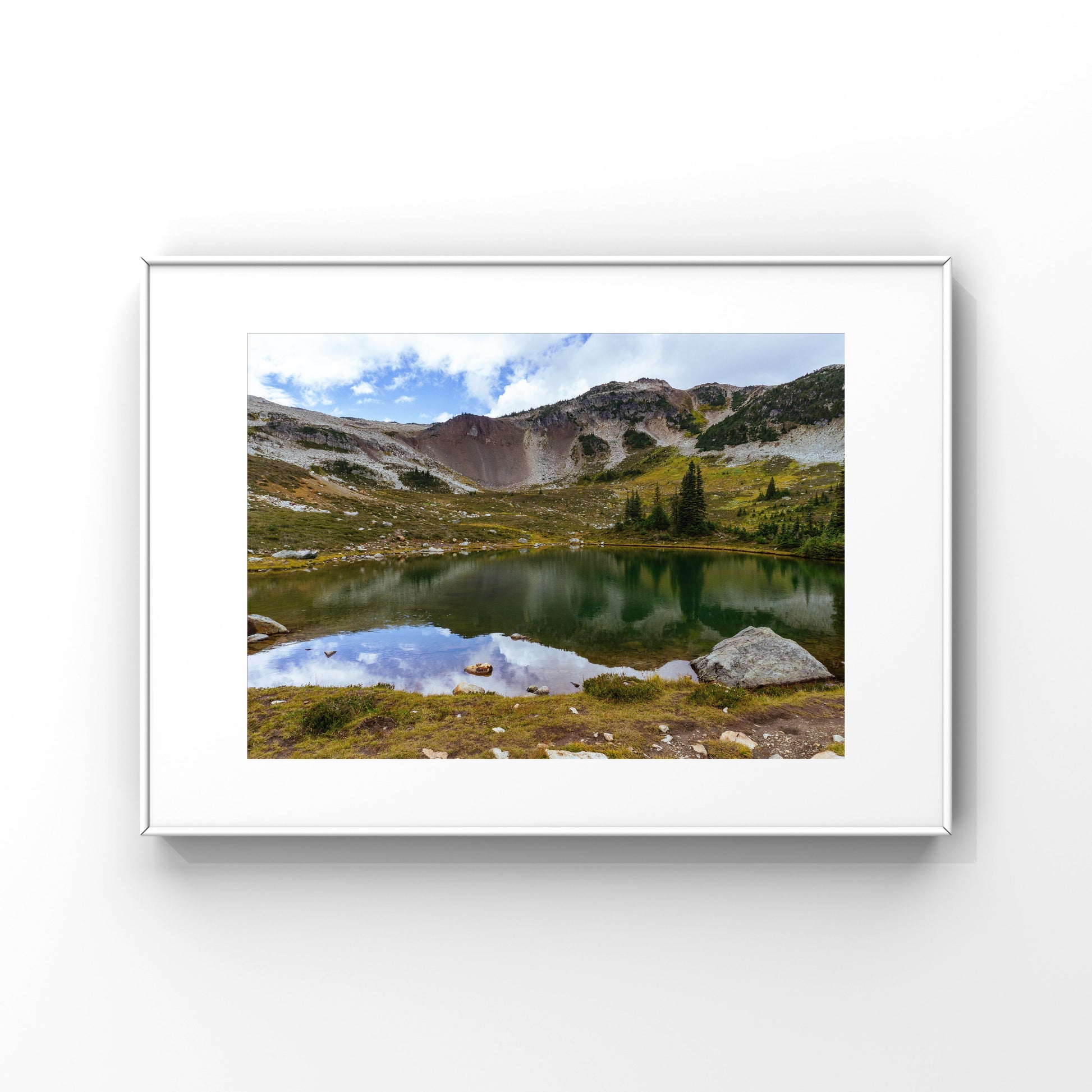 Mountain reflection on an alpine lake in Whistler mountain in British Columbia framed print