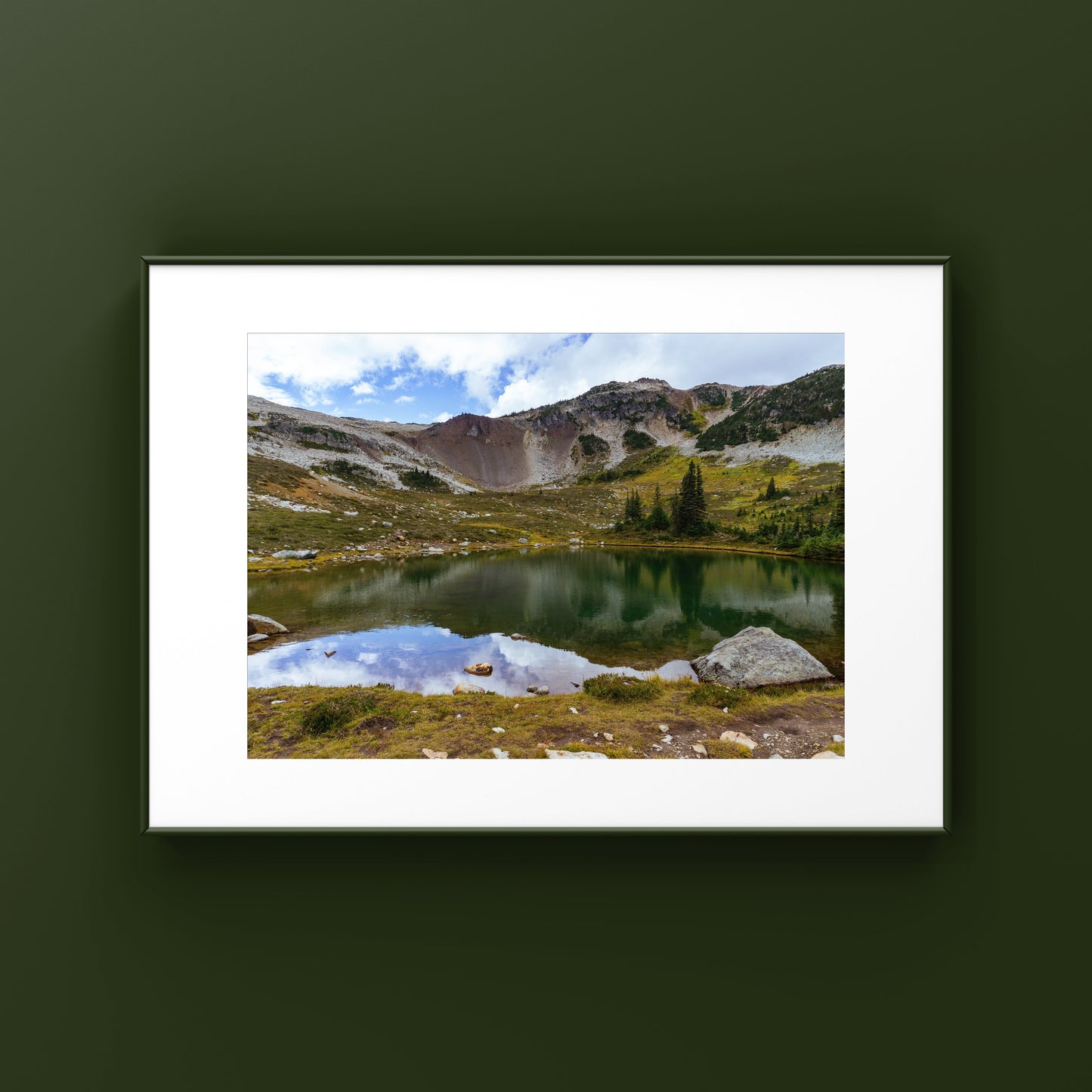 Mountain reflection on an alpine lake in Whistler mountain in British Columbia framed print