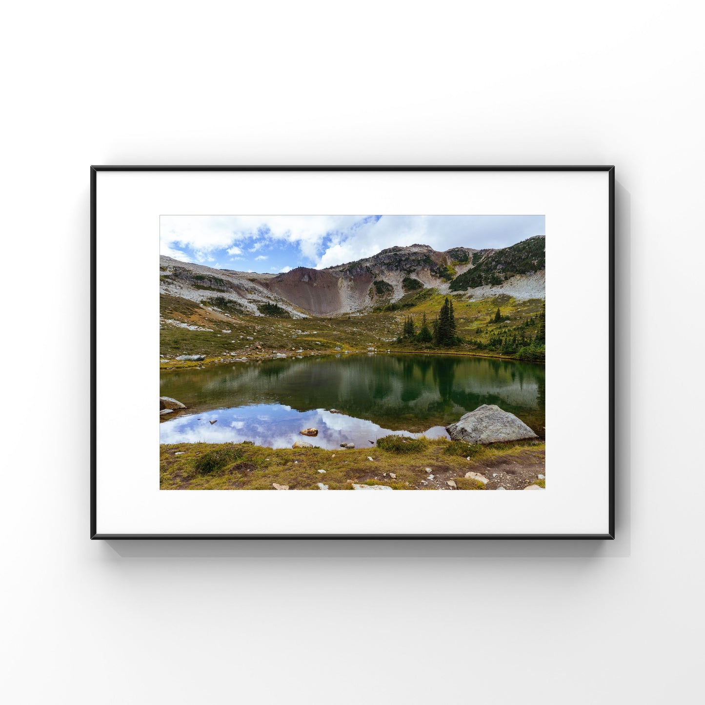 Mountain reflection on an alpine lake in Whistler mountain in British Columbia framed print