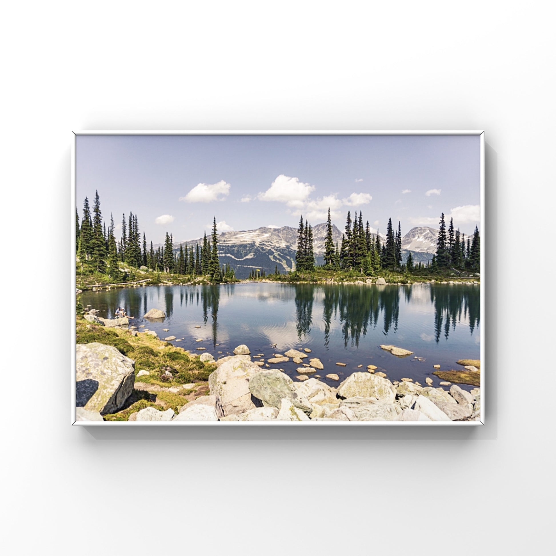 Alpine lake reflection of pine tres and mountains in Whistler, British Columbia in a framed print