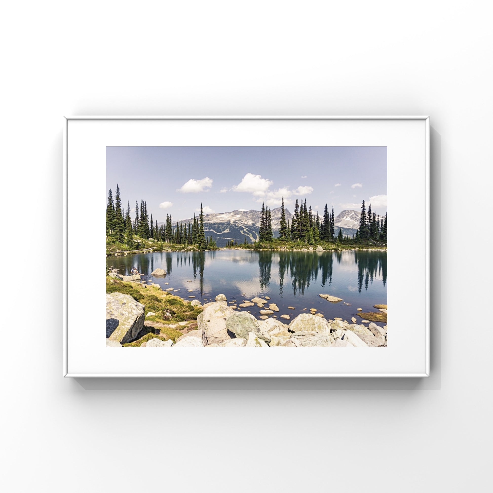 Alpine lake reflection of pine tres and mountains in Whistler, British Columbia in a framed print