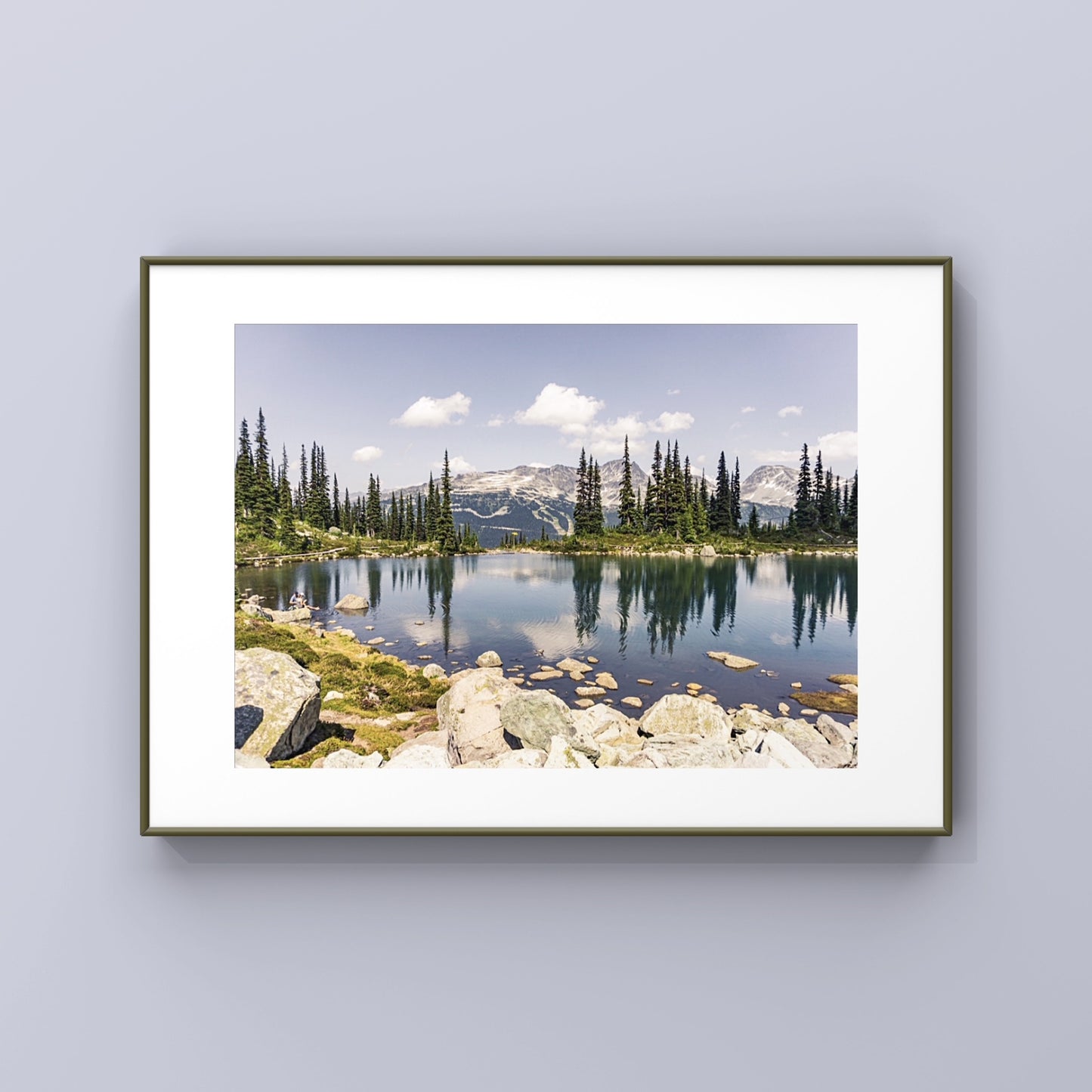 Alpine lake reflection of pine tres and mountains in Whistler, British Columbia in a framed print