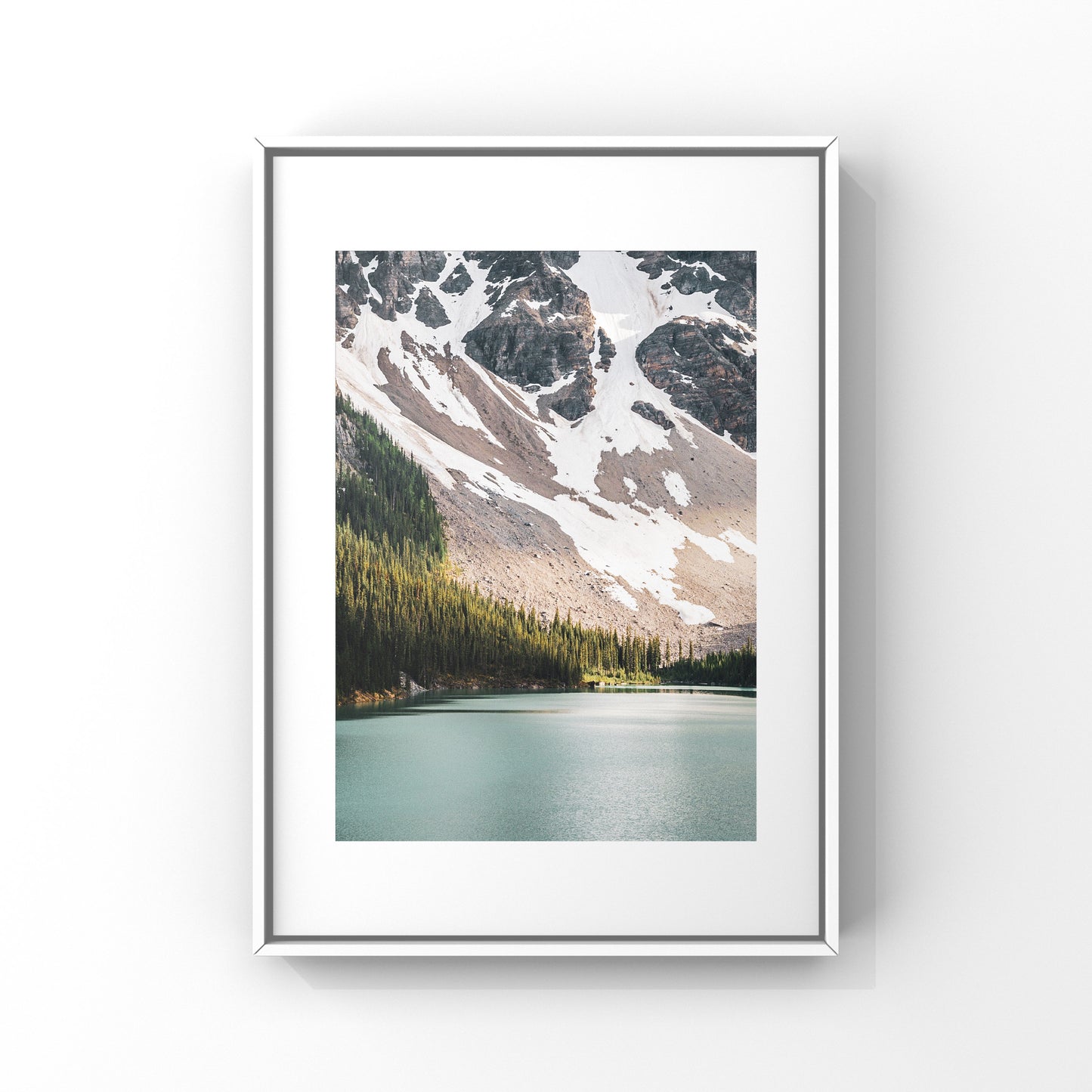 Captivating photograph poster of ray of light shinning on the trees near the glacier water lake close to Lake Louise in Alberta. 