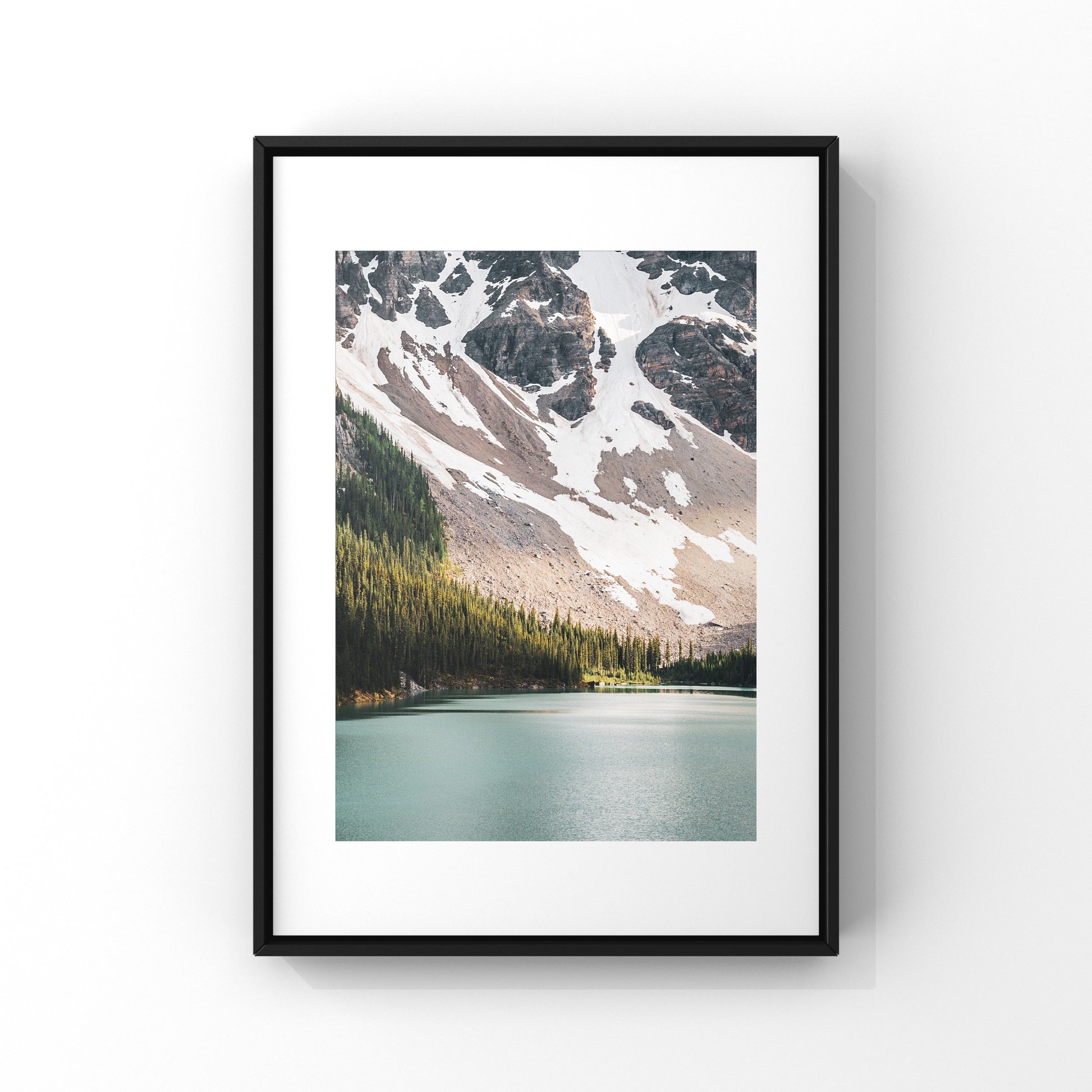 Captivating photograph poster of ray of light shinning on the trees near the glacier water lake close to Lake Louise in Alberta. 